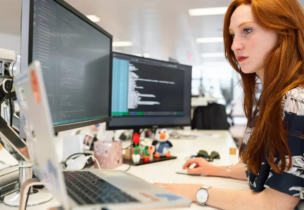 SEO Specialist coding on a PC in a tech office